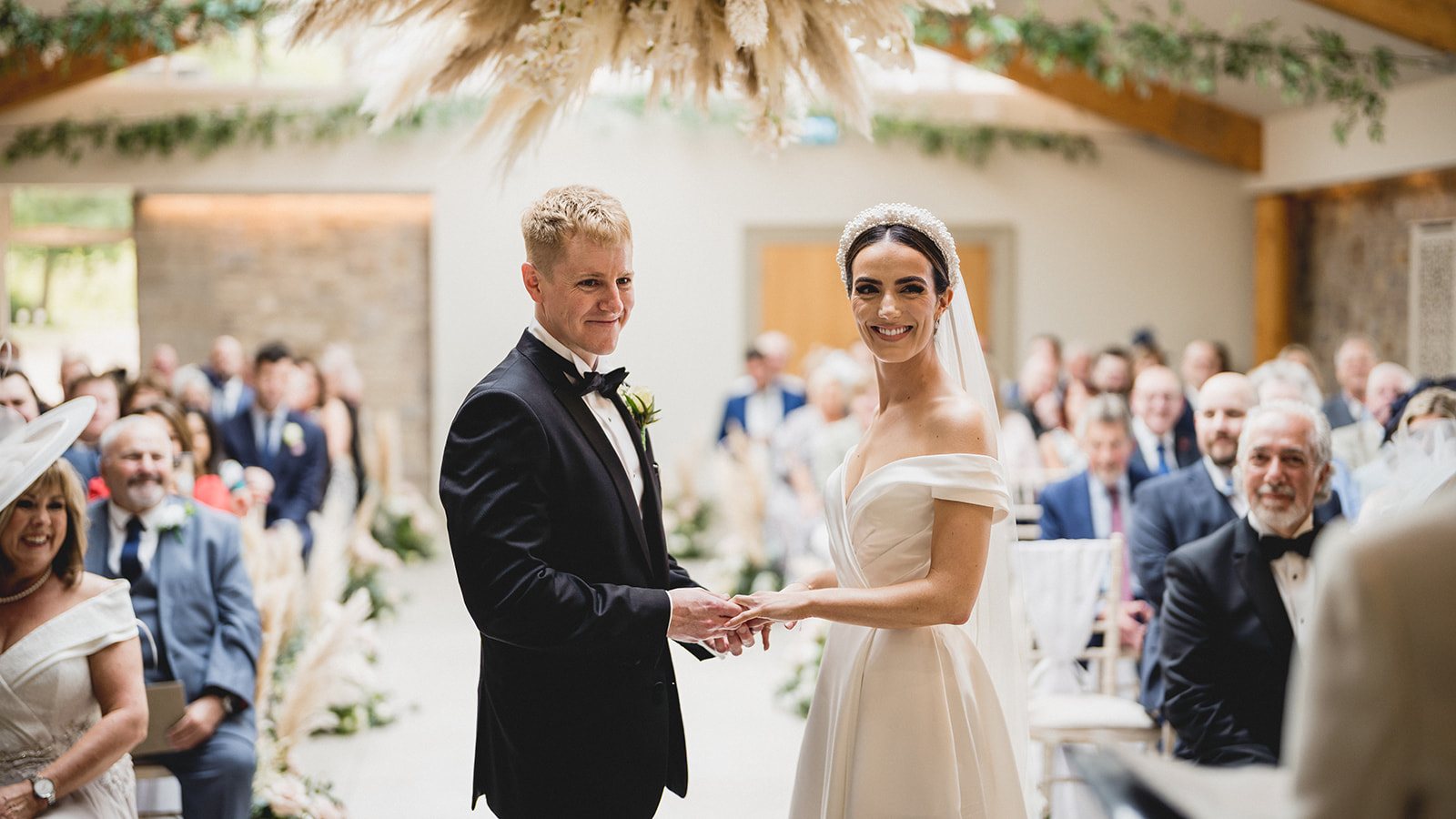 Emily and Craig exchanging rings in the ceremony room