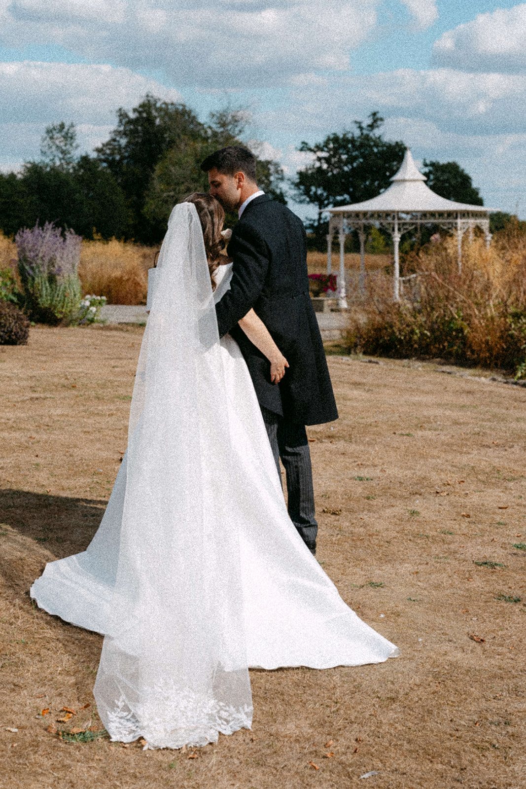 Jess and Tom by the gazebo in the gardens