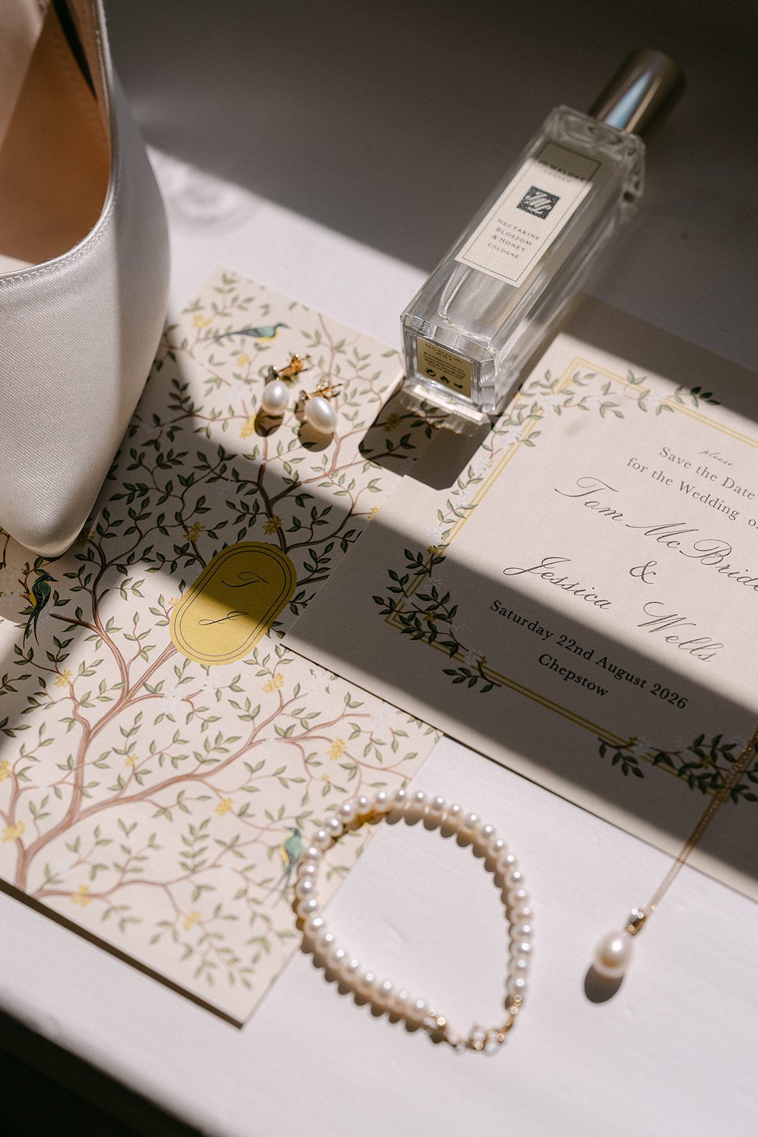 Perfume, earrings and stationery laid out